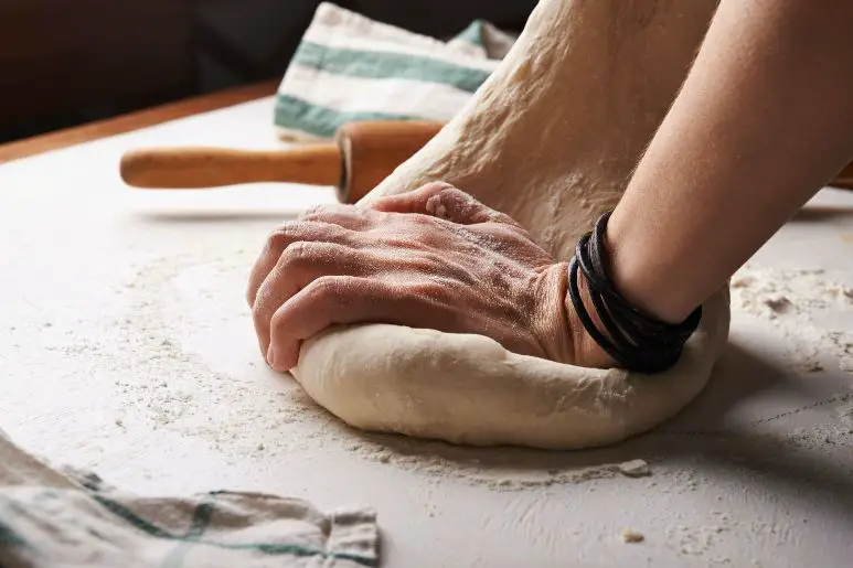 A Person is kneading dough