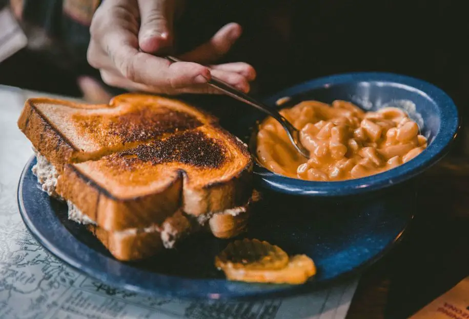 Plate of toasted bread and bowl of bean - How to get rid of yeast taste in bread