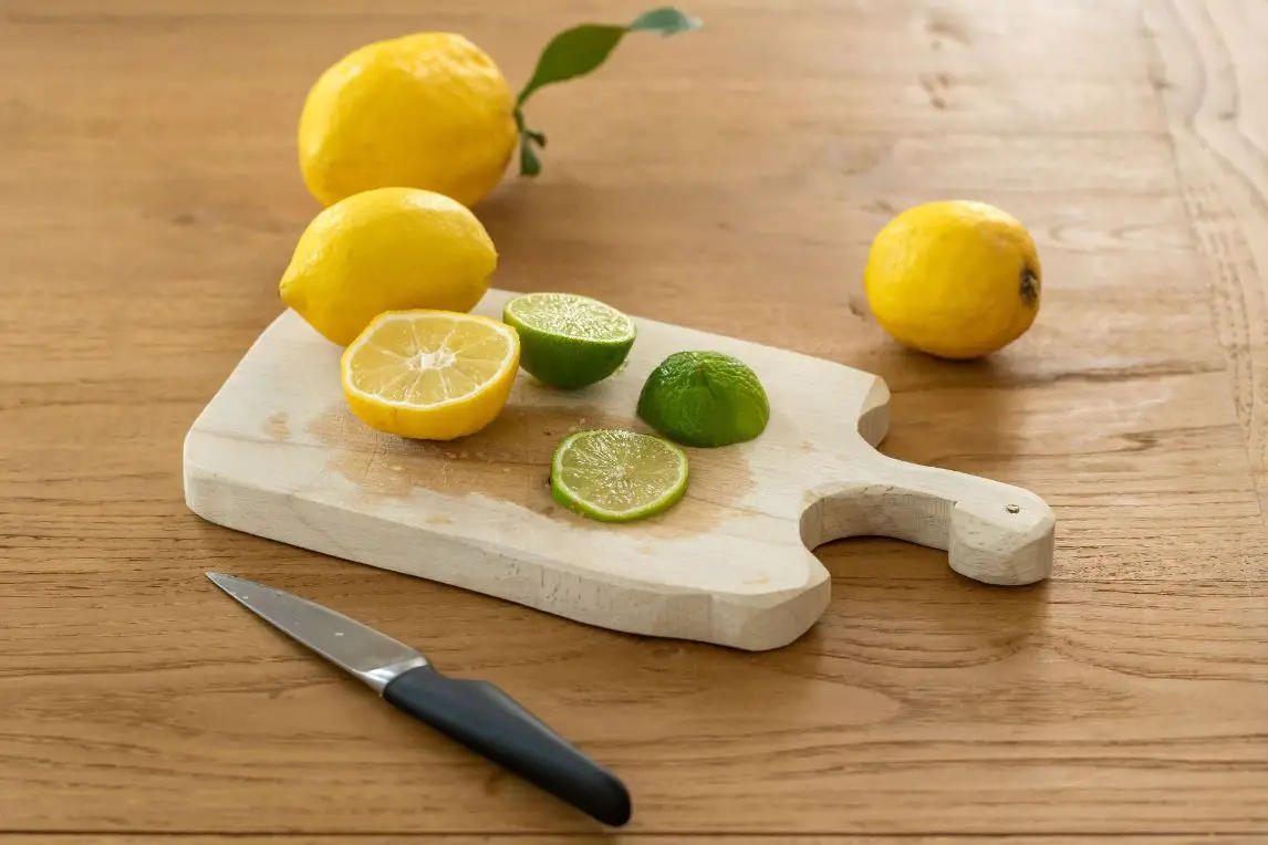 Sliced lemon beside knife on brown wooden chopping board - too much sugar in bread dough
