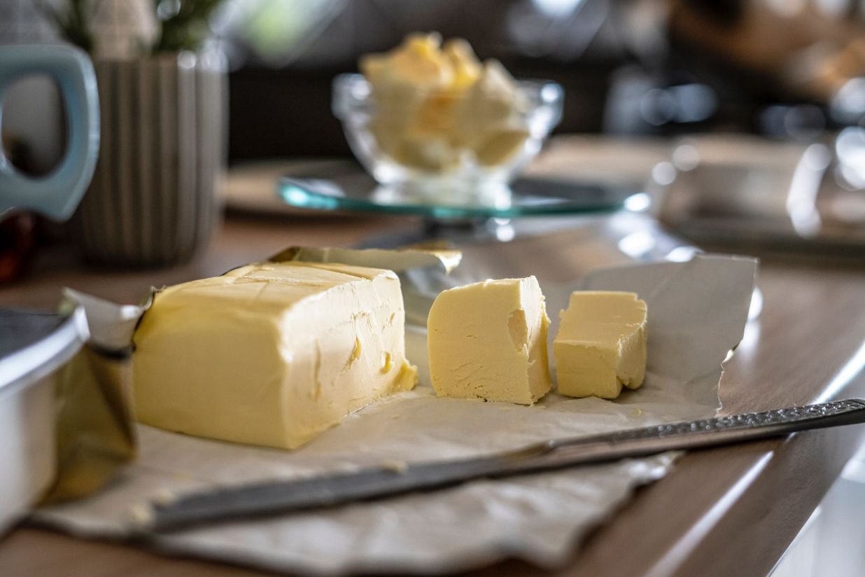 Slices of butter with a kitchen knife - what happens when you add butter to bread dough