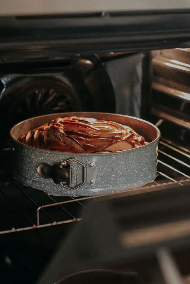 Springform pan that has cake in oven