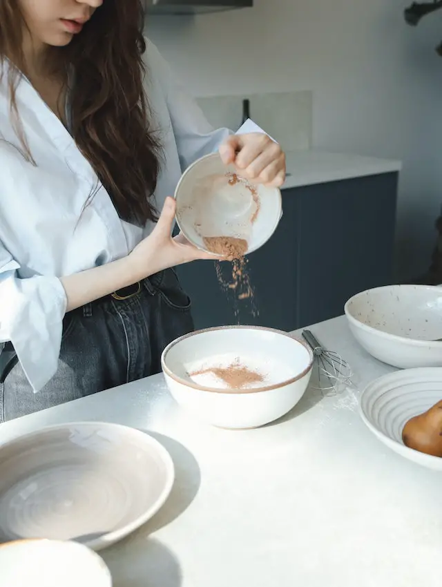 Woman in White Button Up Shirt Holding White Bowl - why does my banana bread taste salty